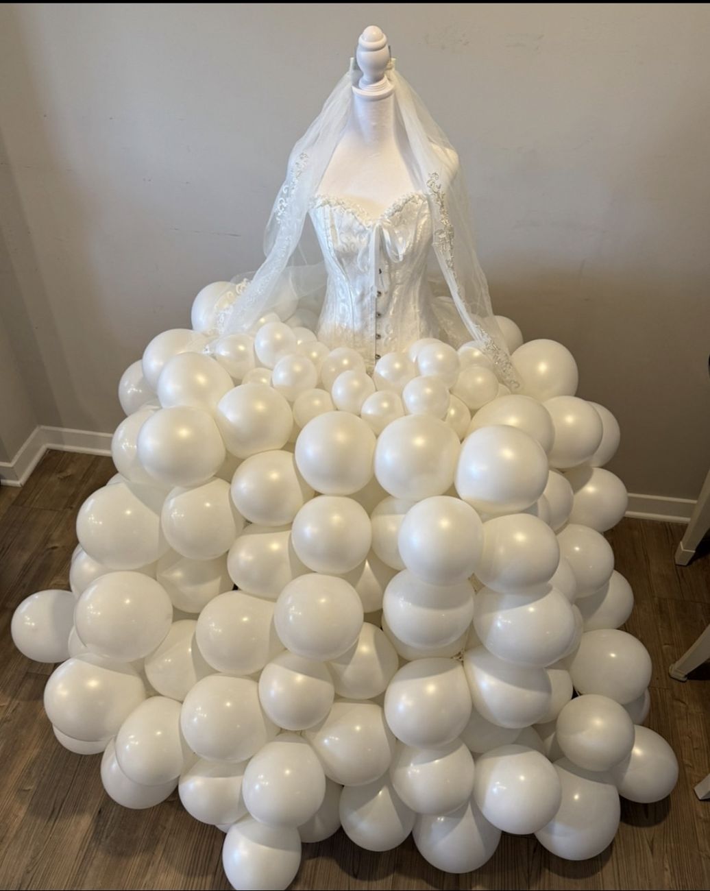 Wedding dress sculpted from white balloons on a mannequin