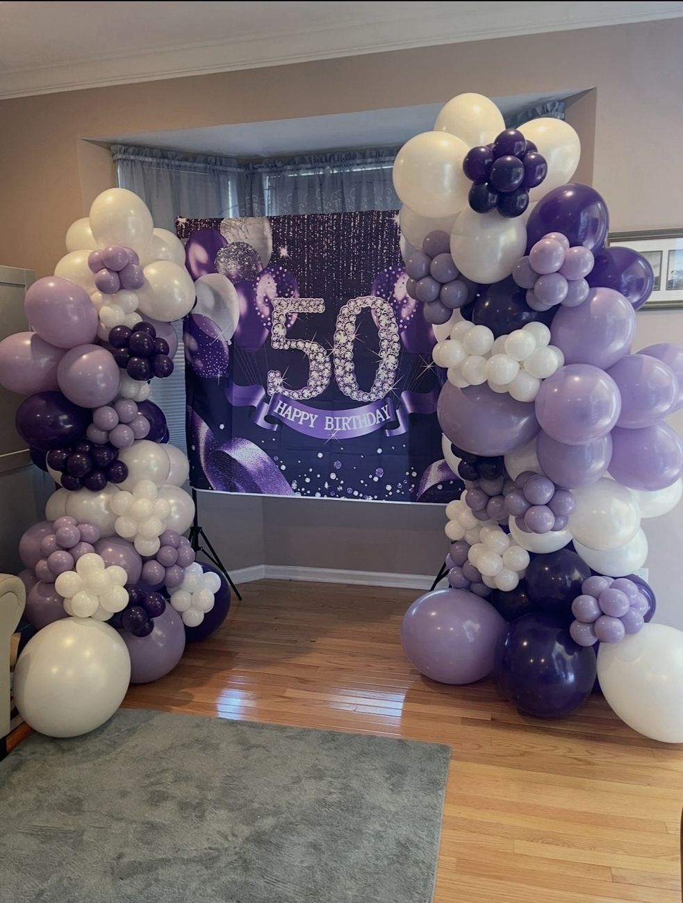 Purple and white organic balloon arch for a 50th birthday