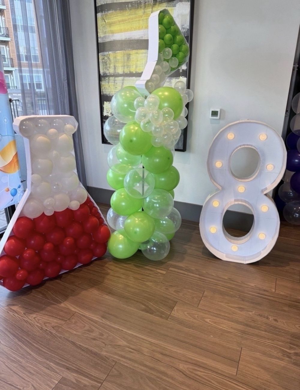 Balloon-filled mosaic beaker and a marquee number 8