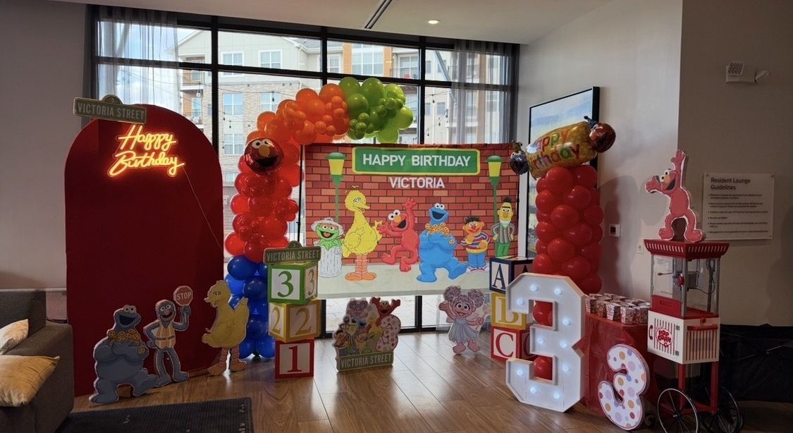 Fully styled third birthday with arch, backdrop, cutouts and popcorn cart