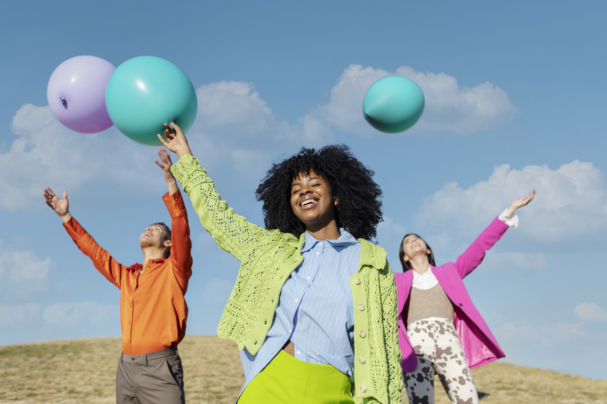 friends-having-fun-with-balloons-outdoor-field